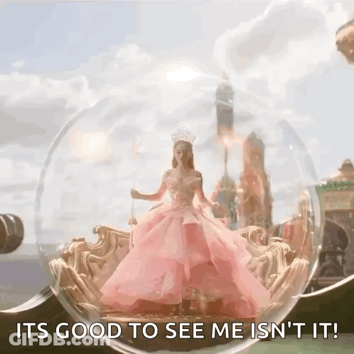 Woman In Pink Dress Inside Glass Ball Saying It's Good To See Me Isn't It GIF