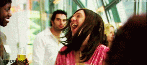 Woman In Pink Dress Laughing Holding Beer GIF