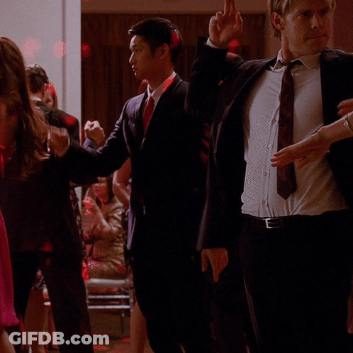 Woman In Pink Dress Next To Man In Suit GIF