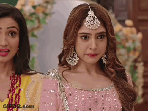 Woman In Pink Dress Next To Woman In Yellow Dress GIF