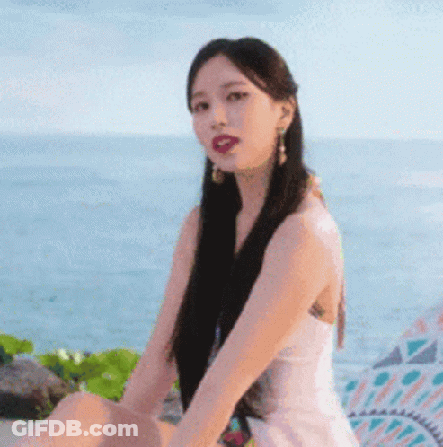 Woman In Pink Dress On Beach Near Ocean GIF