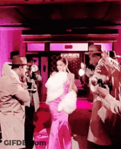 Woman In Pink Dress Photographed By Men GIF