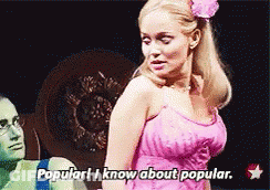 Woman In Pink Dress Saying Popular I Know About Popular GIF