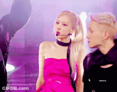Woman In Pink Dress Singing Into Microphone GIF