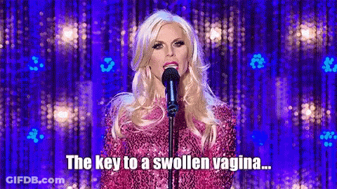 Woman In Pink Dress Singing Into Microphone GIF