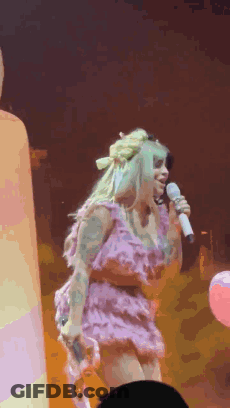 Woman In Pink Dress Singing On Stage GIF