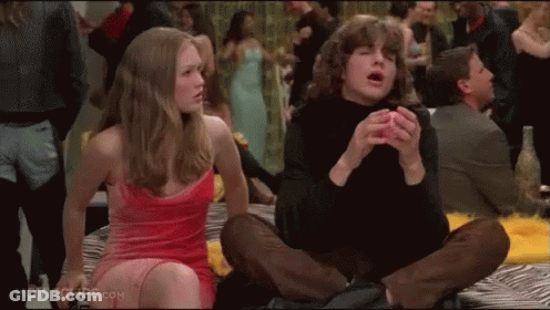 Woman In Pink Dress Sitting Next To Man In Black Shirt GIF