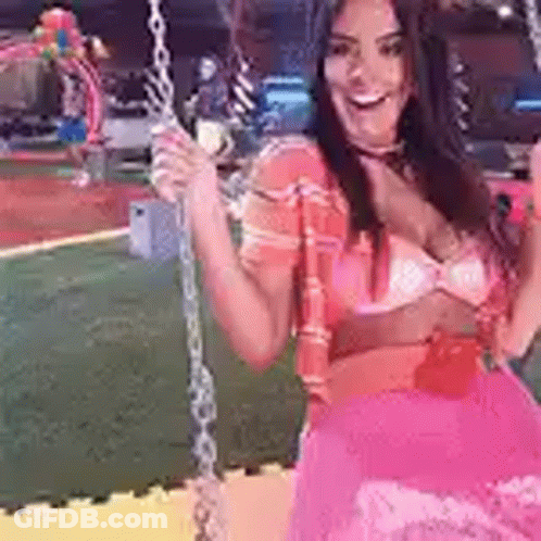 Woman In Pink Dress Sitting On Swing At Playground GIF