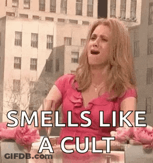 Woman In Pink Dress Sitting With Wine And Flowers GIF