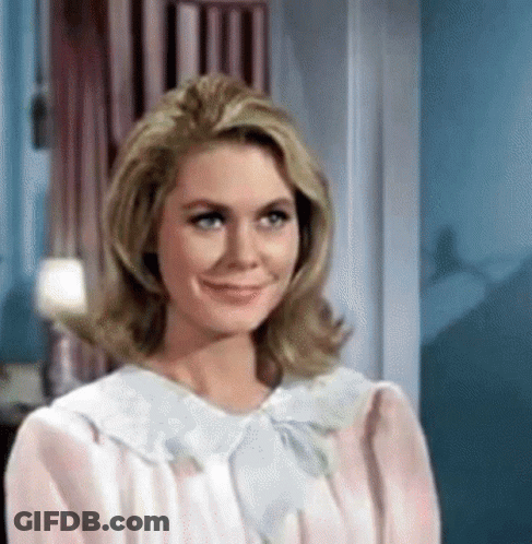 Woman In Pink Dress Smiling At Camera GIF