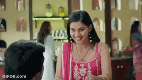 Woman In Pink Dress Smiling At Man GIF