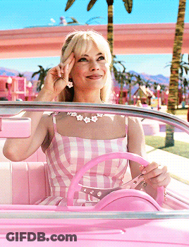 Woman In Pink Dress Smiling Driving Pink Car GIF