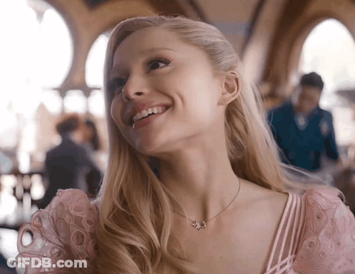 Woman In Pink Dress Smiling With J Necklace GIF