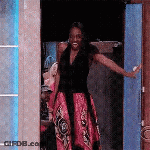 Woman In Pink Dress Standing In Doorway GIF