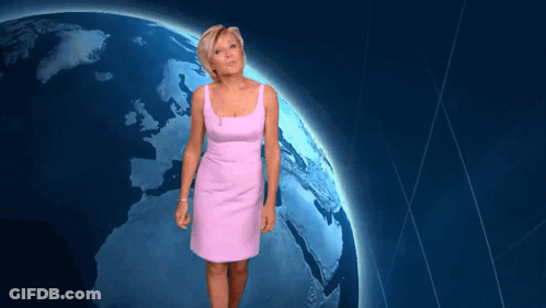 Woman In Pink Dress Standing In Front Of Blue Planet GIF