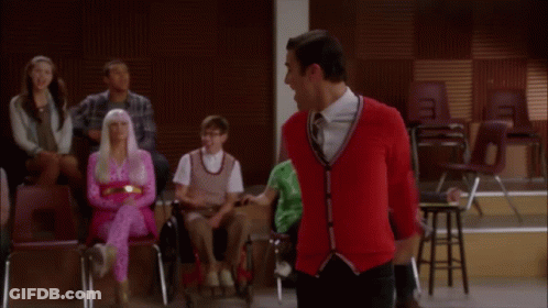 Woman In Pink Dress Standing In Front Of Crowd GIF