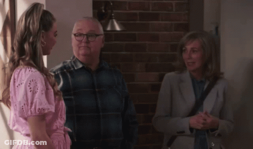 Woman In Pink Dress Talking To Man And Woman GIF