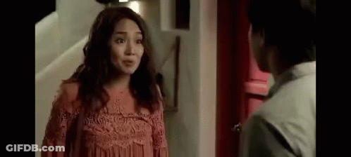Woman In Pink Dress Talking To Man In White GIF