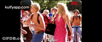 Woman In Pink Dress Talking To Man In Yellow Shirt GIF