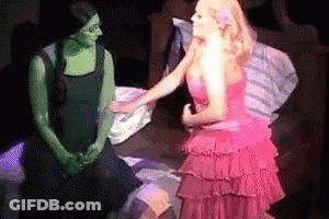 Woman In Pink Dress Talking To Woman In Green Dress GIF
