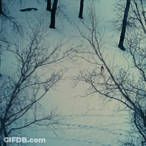 Woman In Pink Dress Walking Through Snow GIF