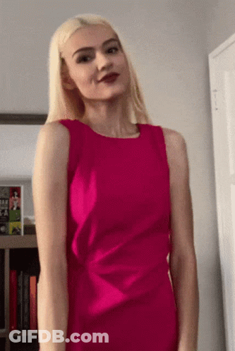 Woman In Pink Dress With Book Titled A Woman GIF