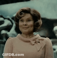 Woman In Pink Dress With Bow Smiling GIF