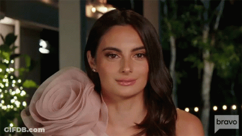 Woman In Pink Dress With Flower On Sleeve GIF