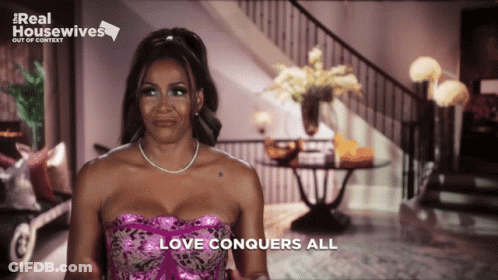 Woman In Pink Dress With Love Conquers All GIF
