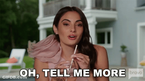 Woman In Pink Dress With Straw: Oh Tell Me More GIF