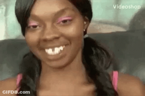 Woman In Pink Eyeshadow And Pigtails Smiling GIF