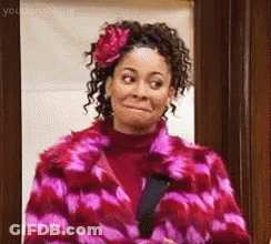 Woman In Pink Fur Coat And Flower Making Funny Face GIF