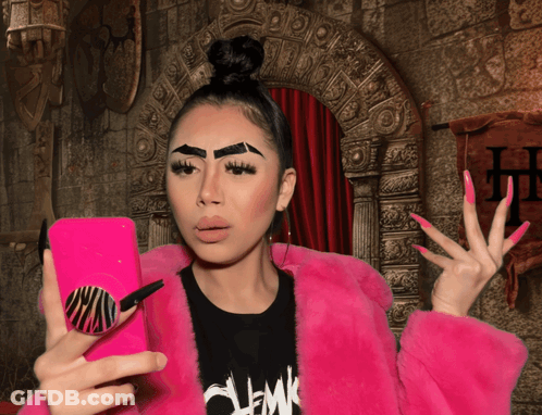 Woman In Pink Fur Coat Taking Selfie GIF