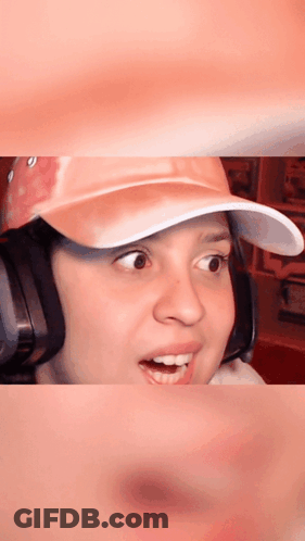 Woman In Pink Hat And Headphones Surprised GIF