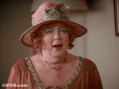 Woman In Pink Hat And Necklace GIF