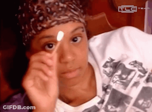 Woman In Pink Hat And Sunglasses Next To Woman In Red Shirt GIF