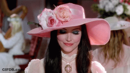 Woman In Pink Hat With Flower GIF