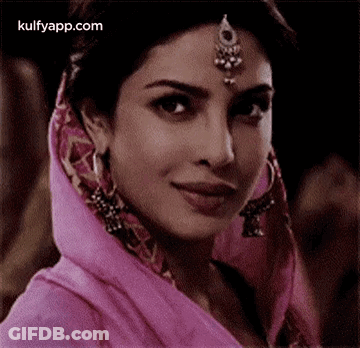Woman In Pink Head Scarf With Earrings GIF