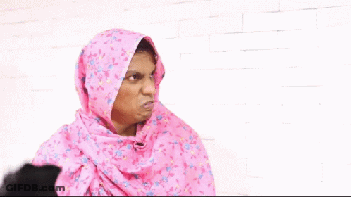 Woman In Pink Hijab Holding Black Shoe GIF