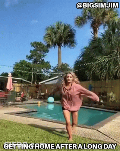 Woman In Pink Hoodie Jumping By Pool Saying Getting Home After A Long Day GIF