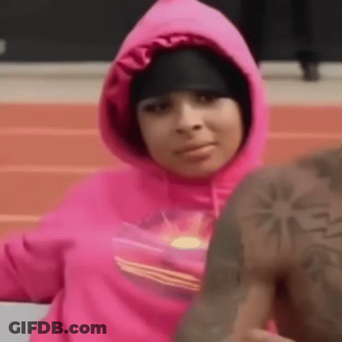Woman In Pink Hoodie Sitting Next To Man In Black Hat GIF