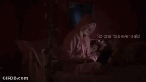 Woman In Pink Hoodie Using Laptop In Bed GIF