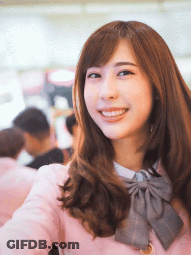 Woman In Pink Jacket And Bow Tie Smiling GIF