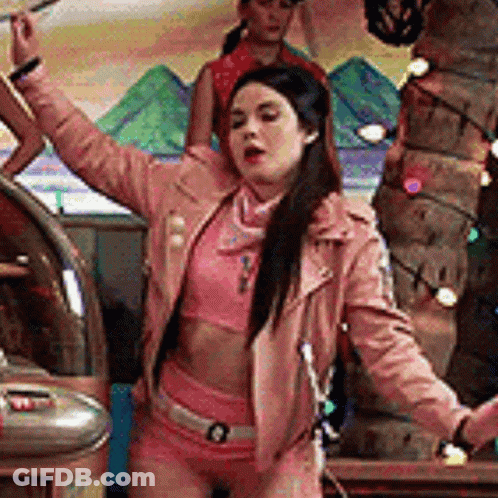 Woman In Pink Jacket And Shorts Dancing With Arms In Air GIF