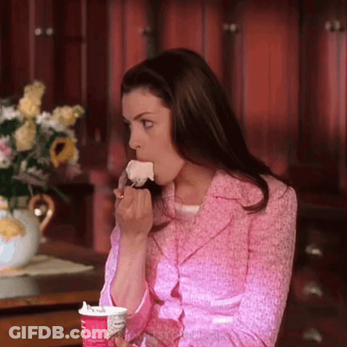 Woman In Pink Jacket Eating Cake From Cup GIF