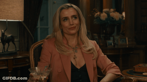 Woman In Pink Jacket Holding Martini GIF