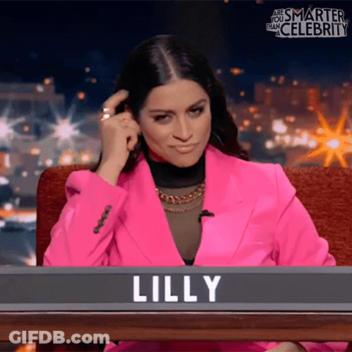 Woman In Pink Jacket In Front Of Lilly Sign GIF