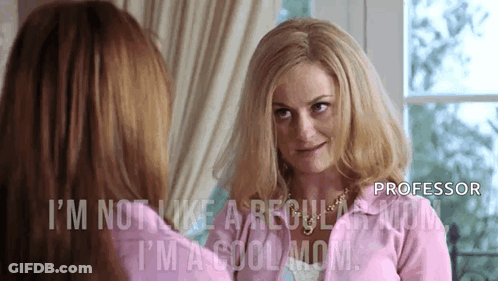 Woman In Pink Jacket Looking In Mirror GIF