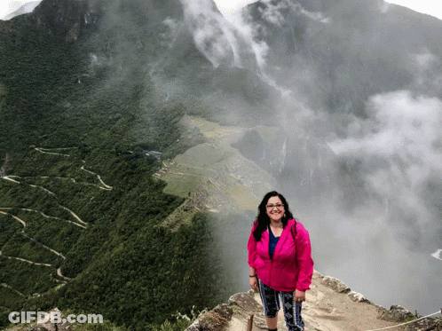 Woman In Pink Jacket On Mountain GIF