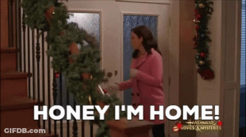 Woman In Pink Jacket Saying Honey I'm Home GIF